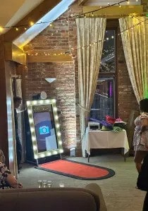 Guests enjoying the magic mirror photo booth at an event