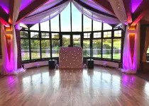 Modern DJ booth setup with lights and sound equipment