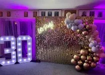 Large illuminated LED letters spelling LOVE at an event