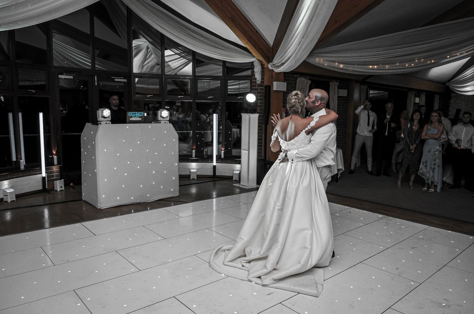 Bride and groom's first dance on a white LED dancefloor at Surrey National Golf Club