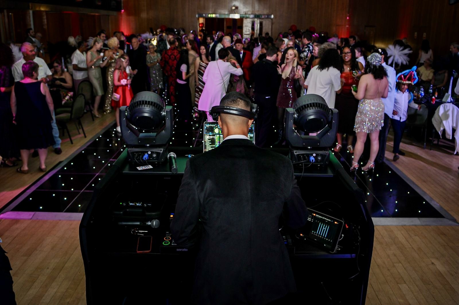 DJ performing to a packed dancefloor at an event at Wandsworth Civic Suite